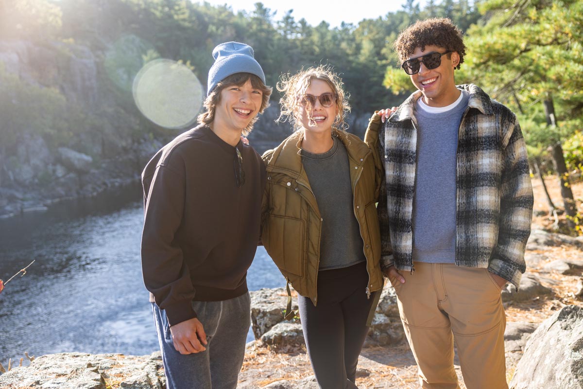3 friends posing for picture infront of mountains